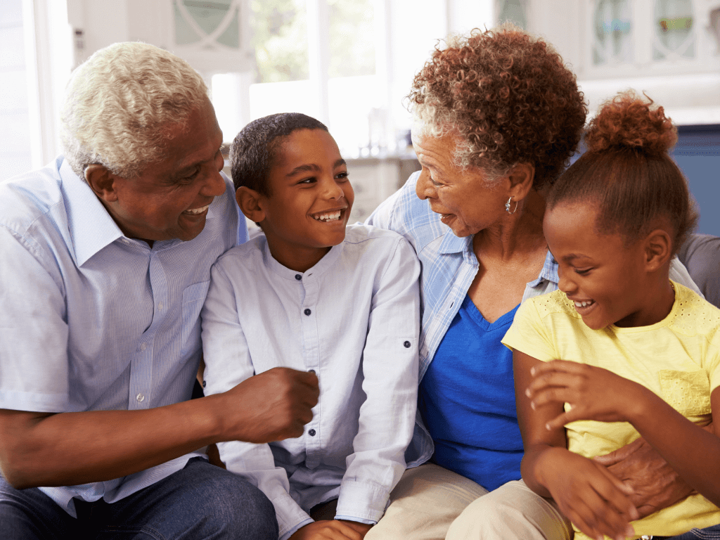 grandparents sitting with their grandchildren