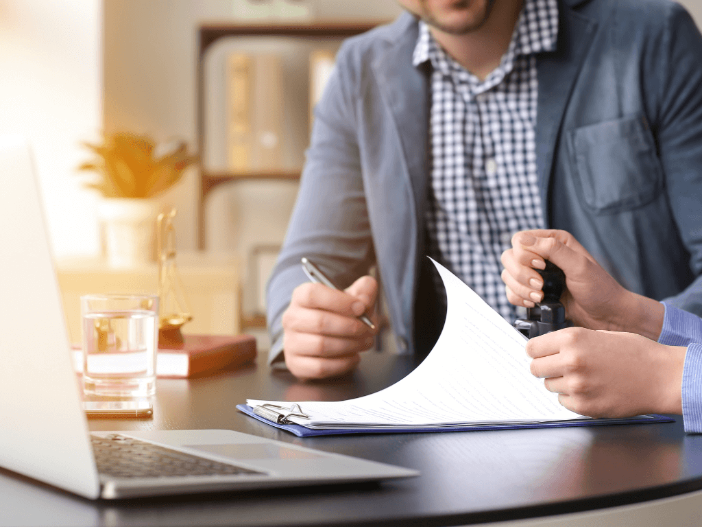 Man signing a waiver of service document with a lawyer