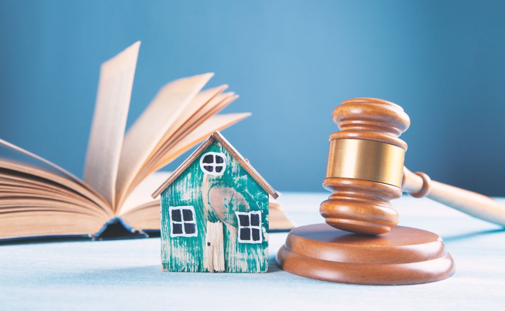 model house next to a gavel
