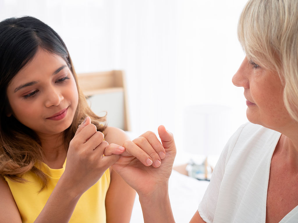 daughter and mother having a pinky promise