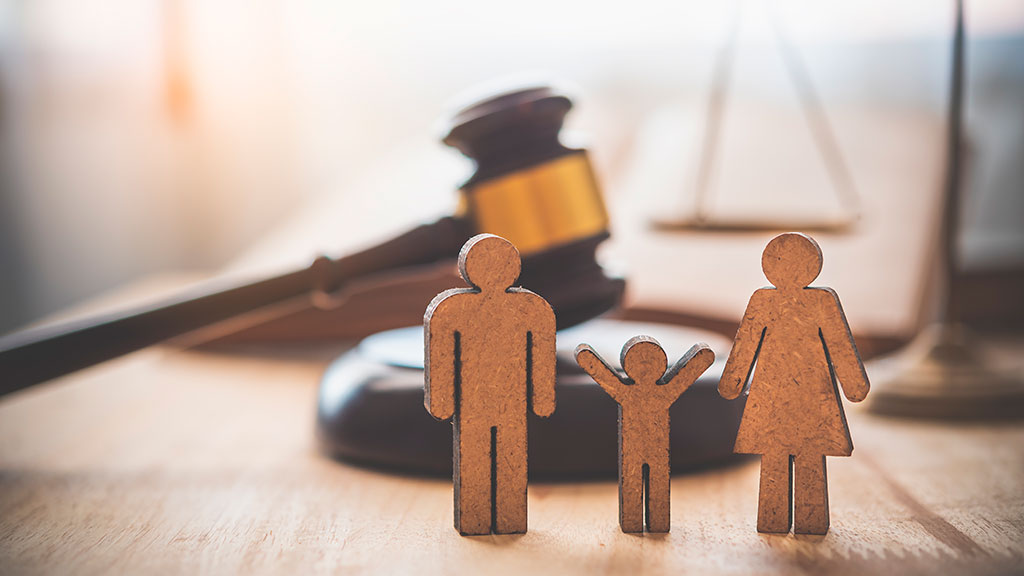 carboard cut out of a family next to a gavel